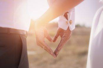 Bride and groom holding his hands